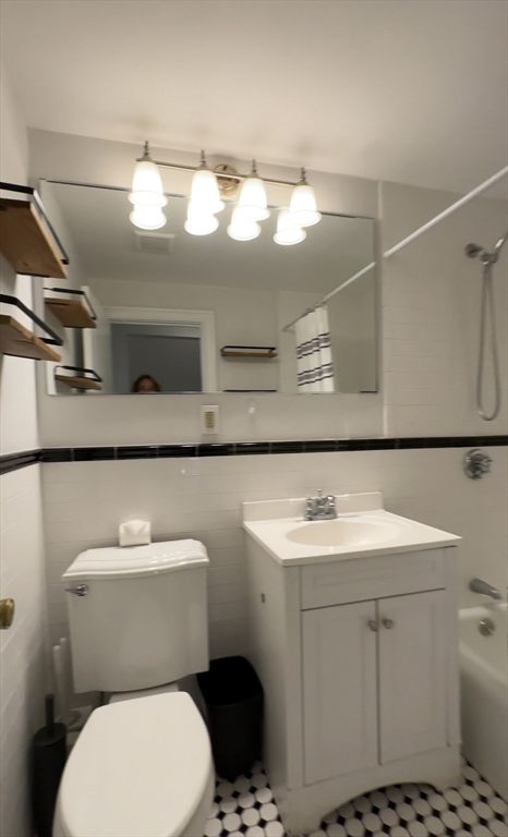 12 Follen Street, Unit ONEA Boston, MA 02116 - Photo 9 of 23 a bathroom with a sink toilet and mirror