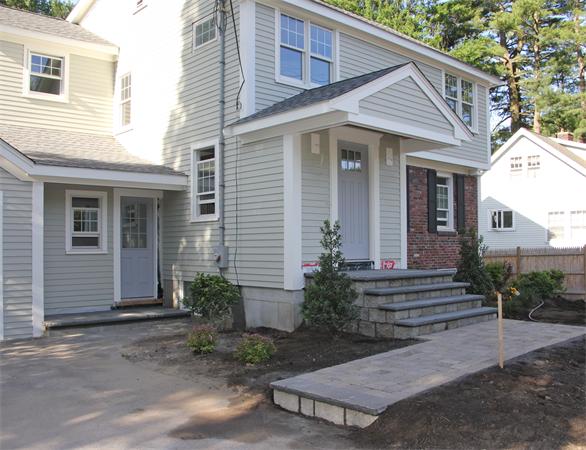 298 Brookline Street Needham, MA 02492 - Photo 2 of 4 a view of a house with small yard plants and a large tree