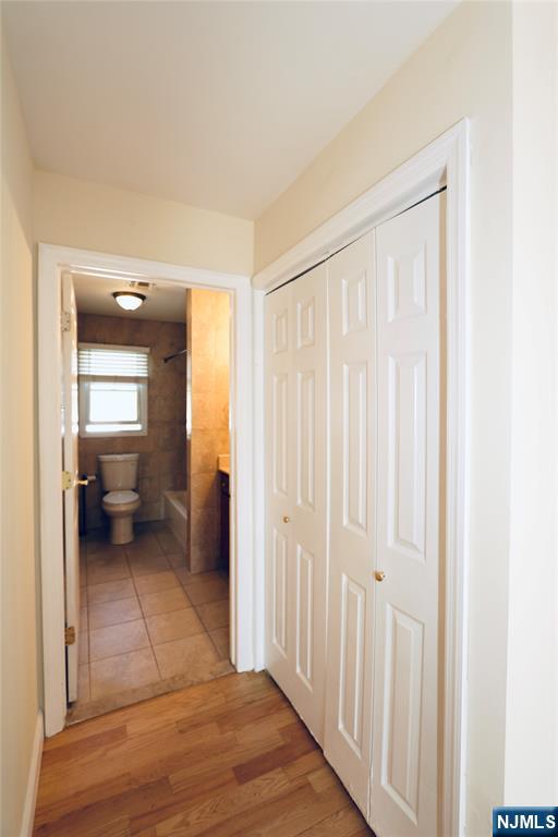 23 Main Avenue Wallington, NJ 07057 - Photo 12 of 29 a view of a hallway with wooden floor and a bathroom