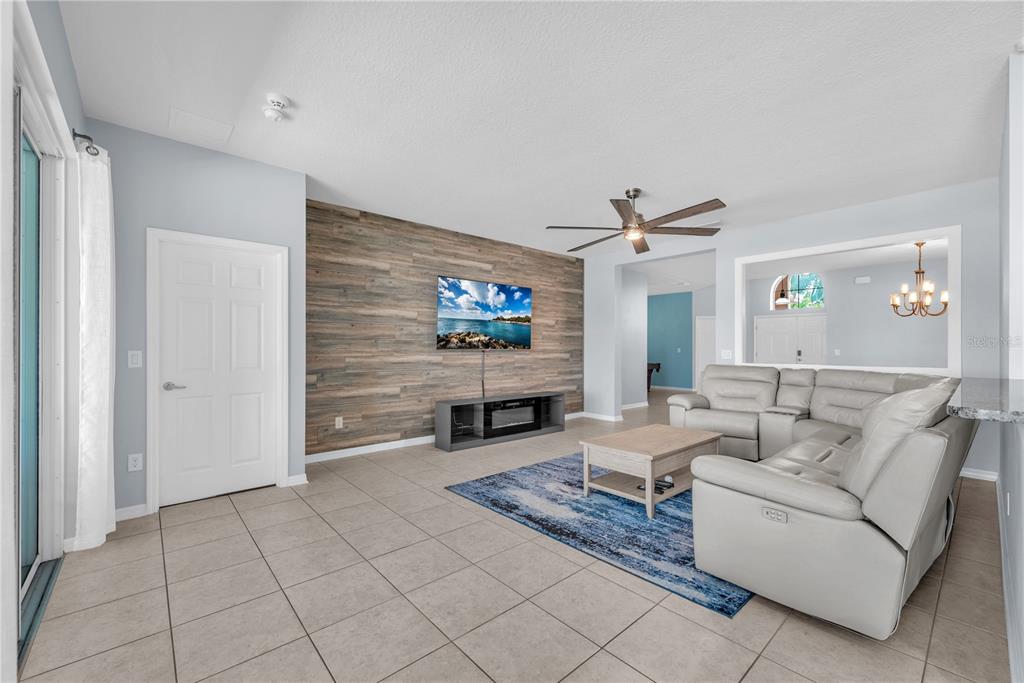 11236 77th Street East Parrish, FL 34219 - Photo 15 of 53 a living room with furniture a fireplace and a flat screen tv