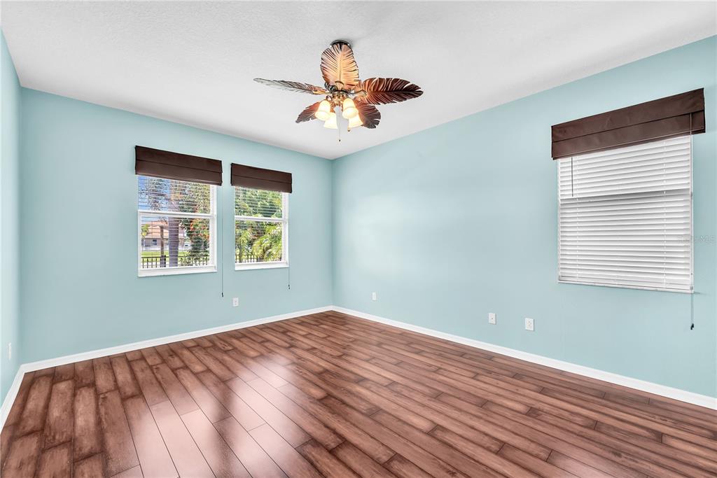 11236 77th Street East Parrish, FL 34219 - Photo 16 of 53 a view of an empty room with wooden floor and a window