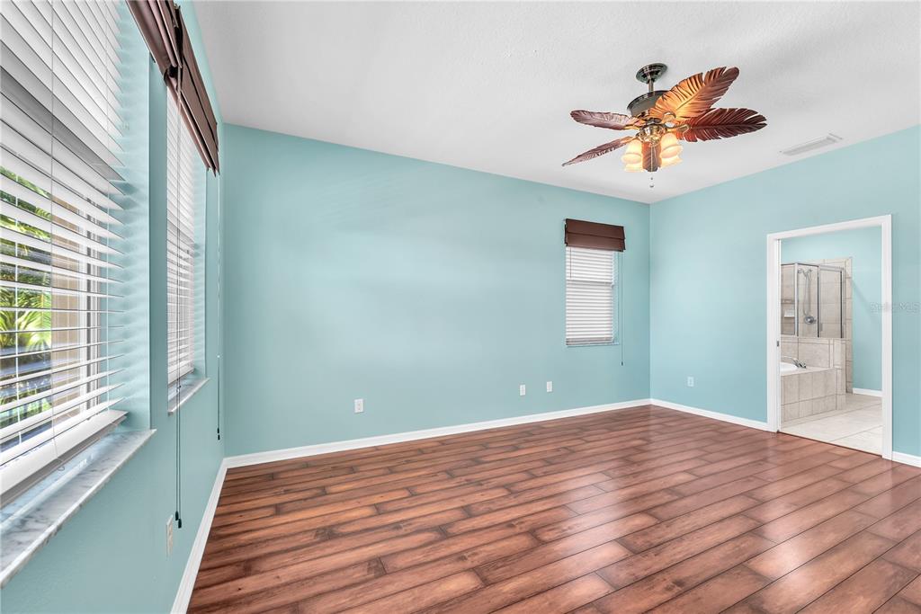 11236 77th Street East Parrish, FL 34219 - Photo 17 of 53 a bedroom with a bed and a large window