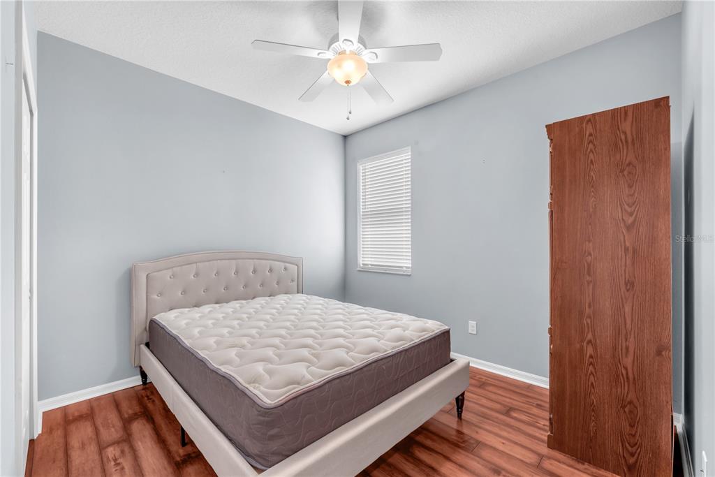 11236 77th Street East Parrish, FL 34219 - Photo 20 of 53 a bedroom with a bed and a chandelier