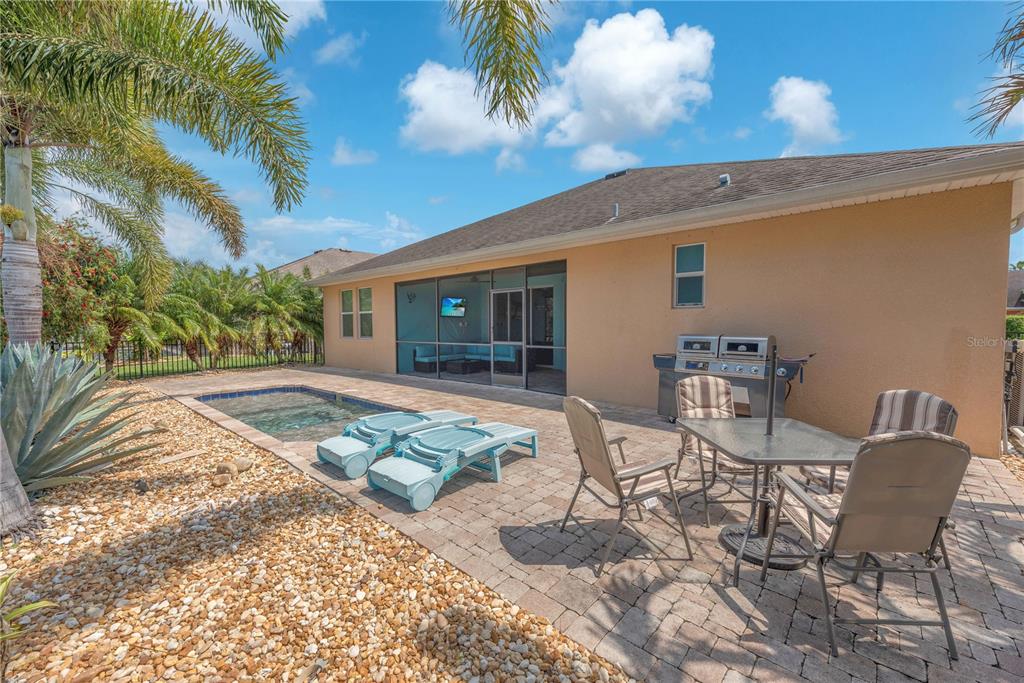 11236 77th Street East Parrish, FL 34219 - Photo 29 of 53 a view of a patio with table and chairs with wooden floor and fence