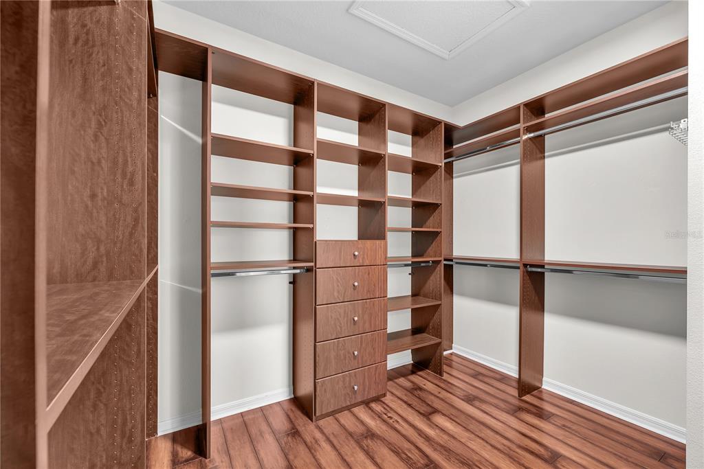 11236 77th Street East Parrish, FL 34219 - Photo 3 of 53 a view of walk in closet with empty racks