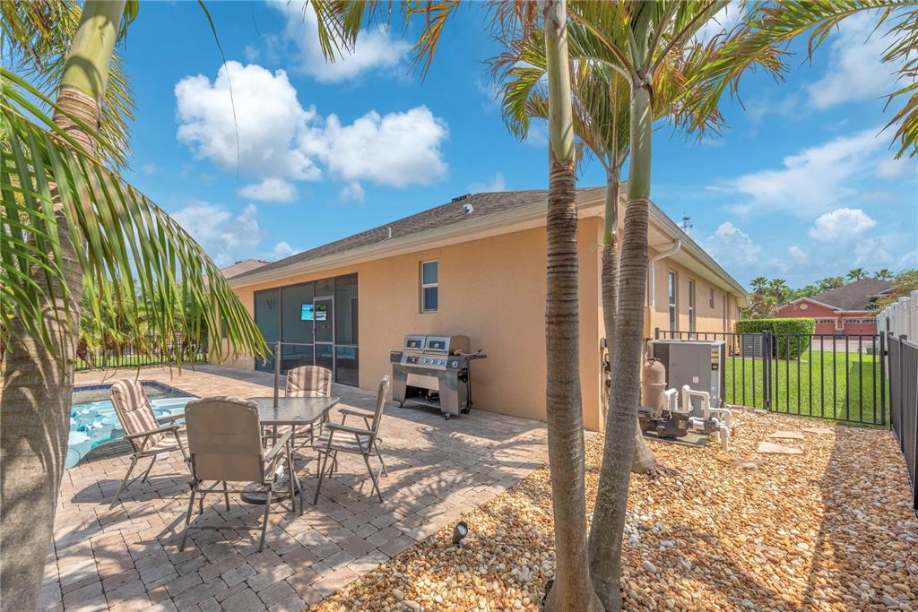 11236 77th Street East Parrish, FL 34219 - Photo 34 of 53 a view of a patio with a table and chairs and a fire pit