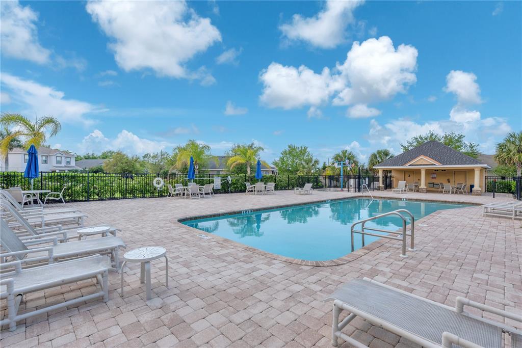 11236 77th Street East Parrish, FL 34219 - Photo 52 of 53 a view of a swimming pool and lounge chairs in patio