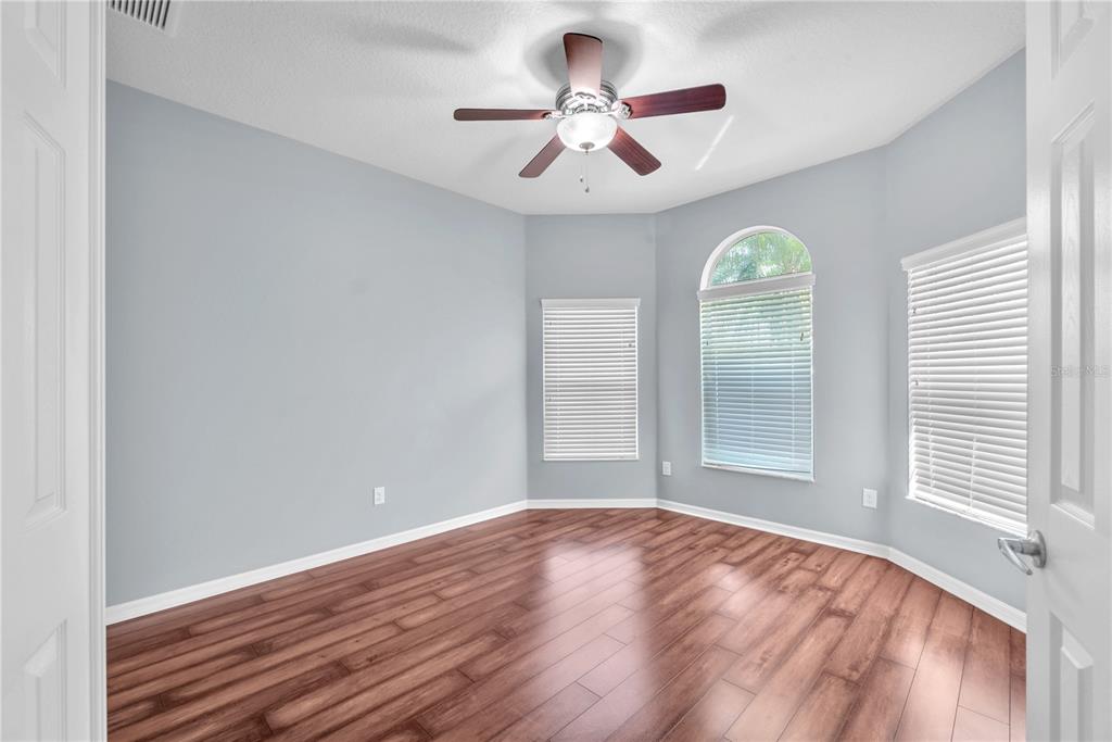 11236 77th Street East Parrish, FL 34219 - Photo 9 of 53 a view of empty room with wooden floor and fan