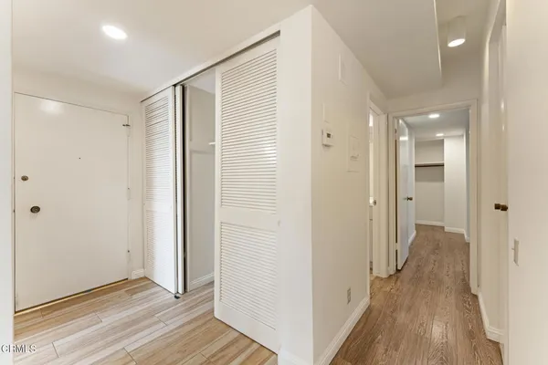a view of a hallway with wooden floor