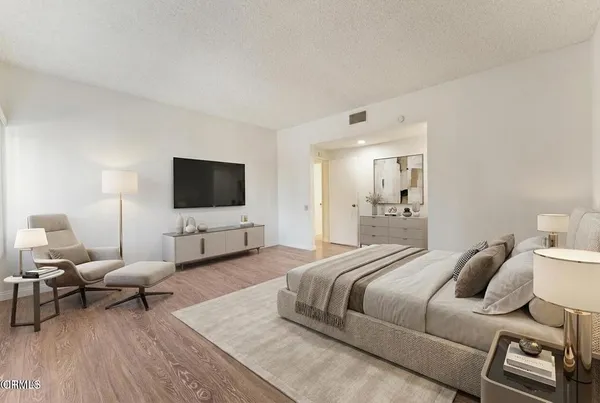 a bedroom with a bed and a flat screen tv