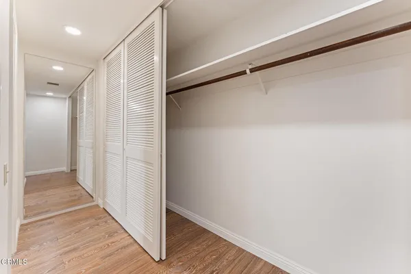a view of hallway with wooden floor