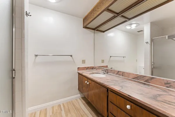 a view of bathroom with a sink and mirror