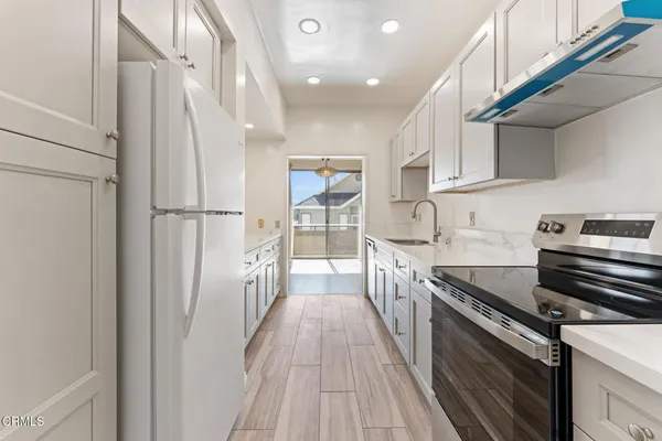 a kitchen with stainless steel appliances a refrigerator and a stove
