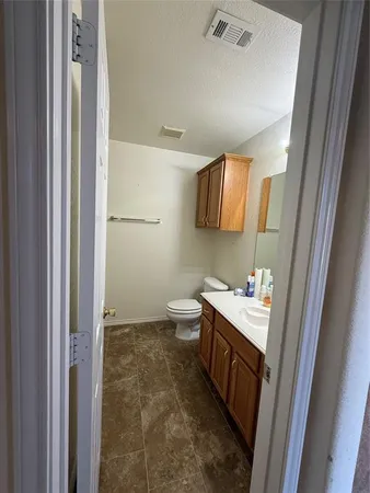 a bathroom with a toilet sink and mirror