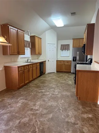 a large kitchen with kitchen island granite countertop a sink and counter space
