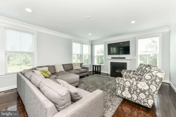 a living room with furniture fireplace and a flat screen tv