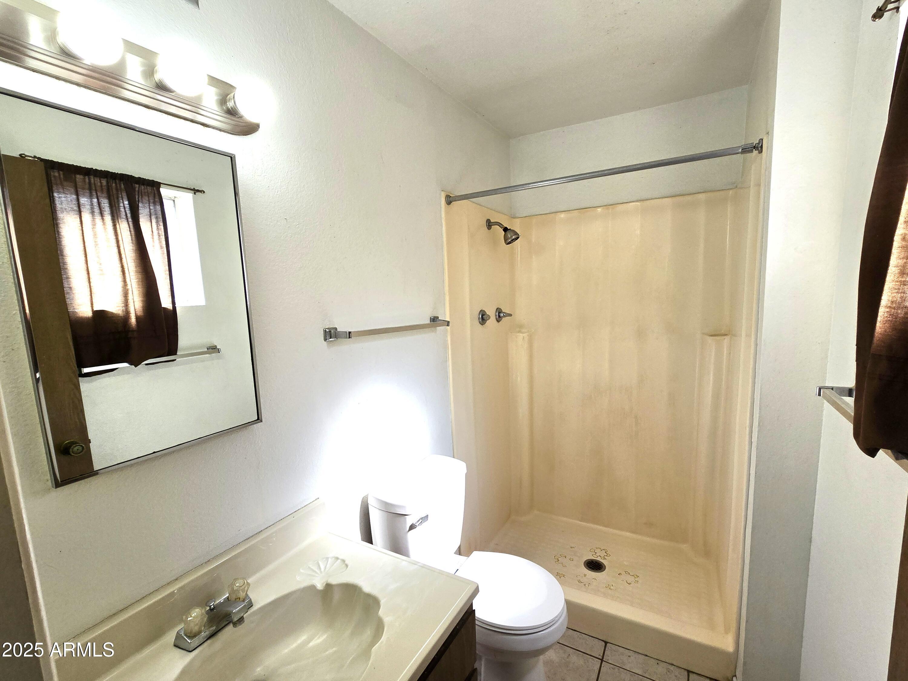 141 North Date, Unit 7 Mesa, AZ 85201 - Photo 8 of 15 a bathroom with a sink toilet and shower