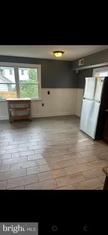 a view of a hardwood floor and a window