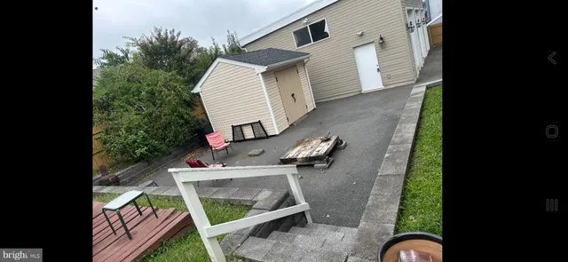 an aerial view of a house with outdoor space furniture