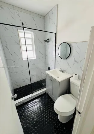 a bathroom with a sink toilet and shower