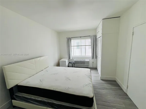 a bedroom with a bed and window
