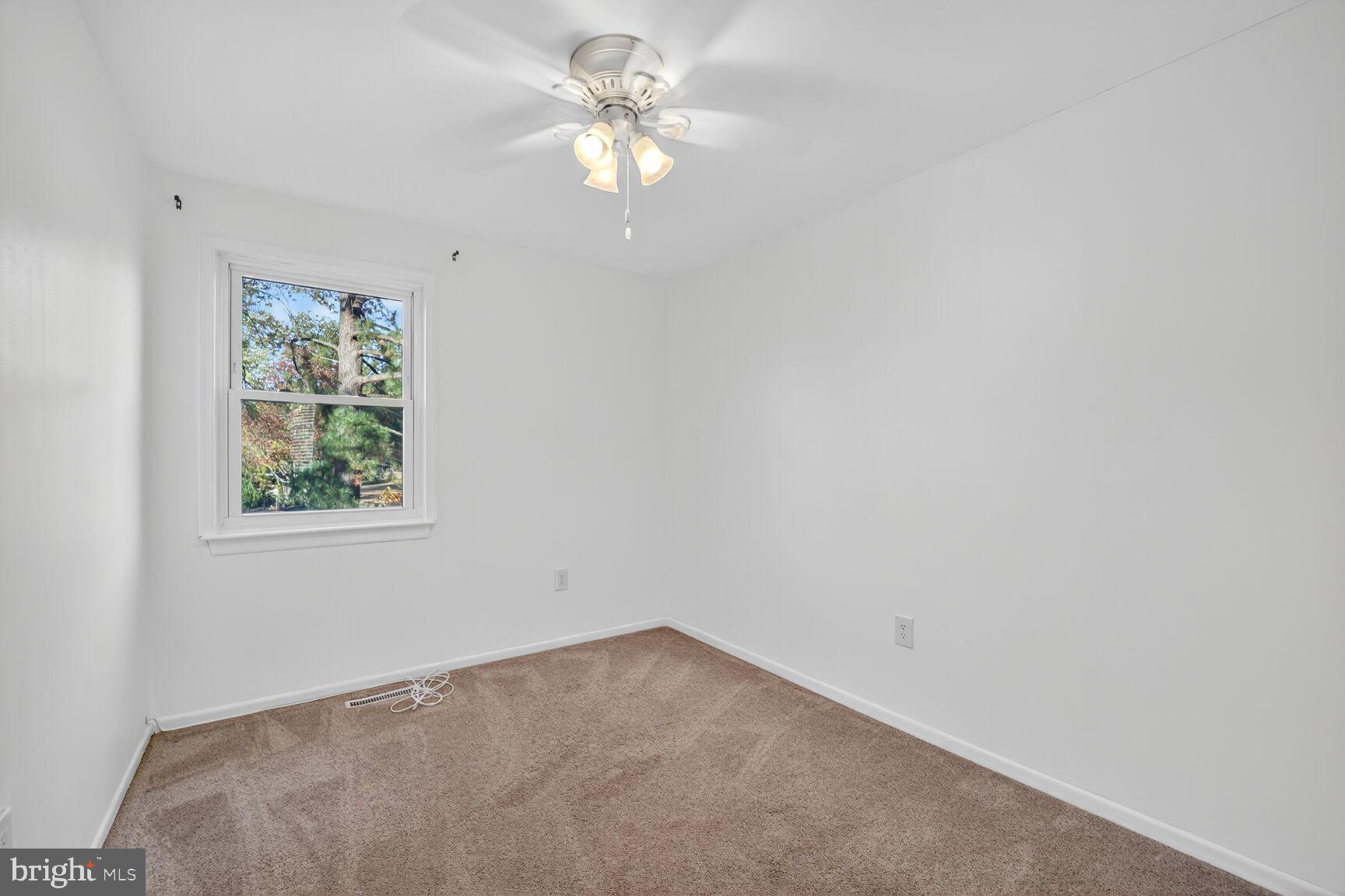 779 Match Point Drive Arnold, MD 21012 - Photo 19 of 28 an empty room with a window and a ceiling fan