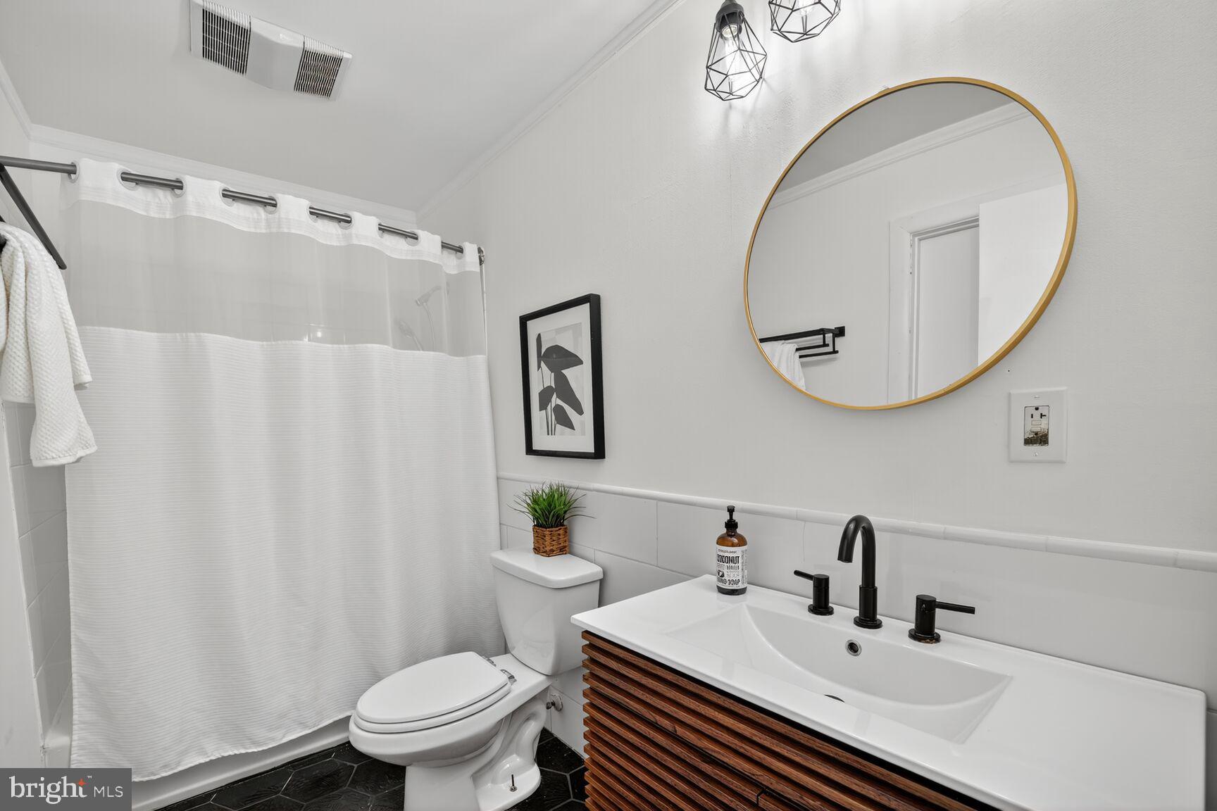 779 Match Point Drive Arnold, MD 21012 - Photo 23 of 28 a bathroom with a sink a toilet and a mirror