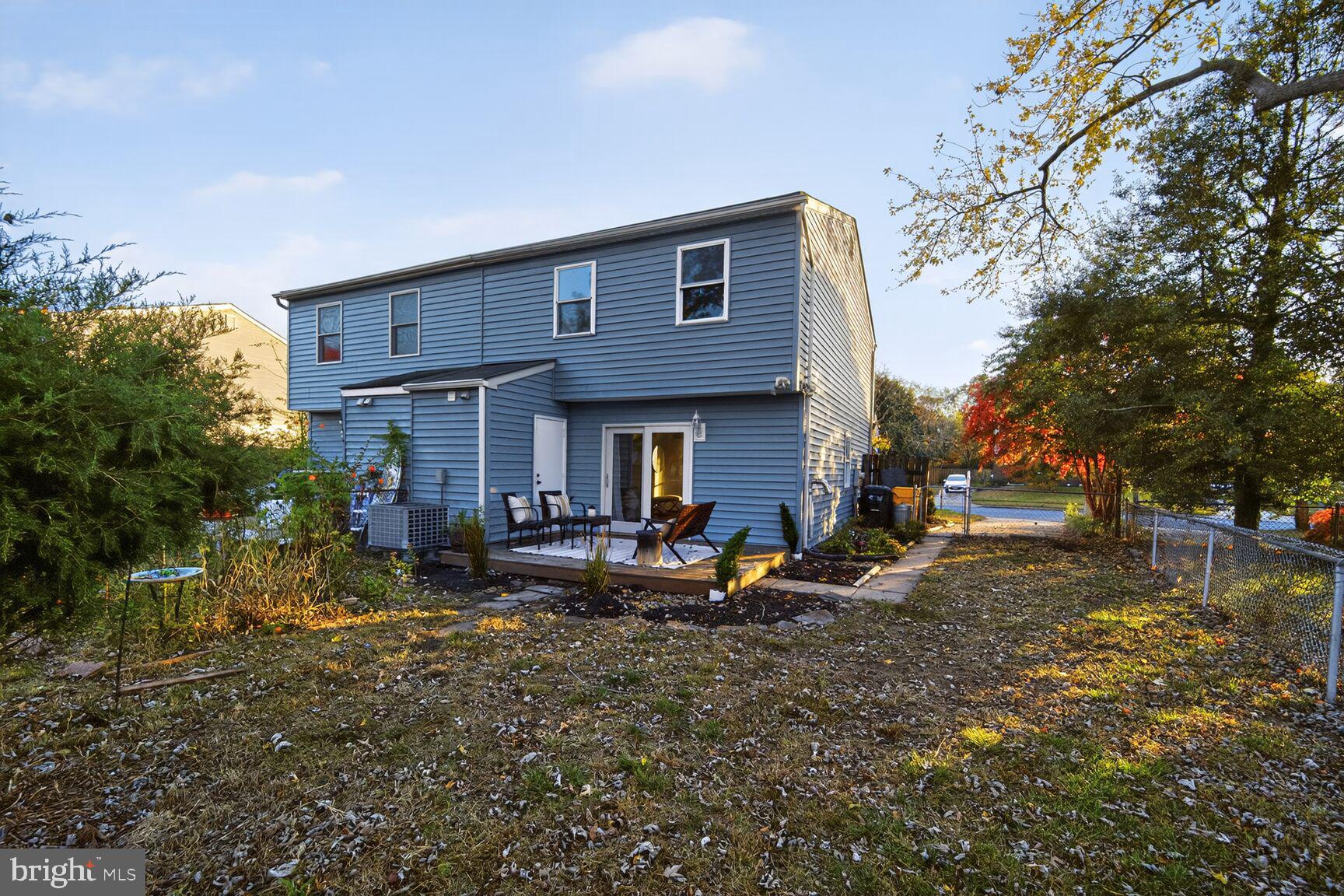 779 Match Point Drive Arnold, MD 21012 - Photo 25 of 28 a view of a brick house with many windows next to a yard