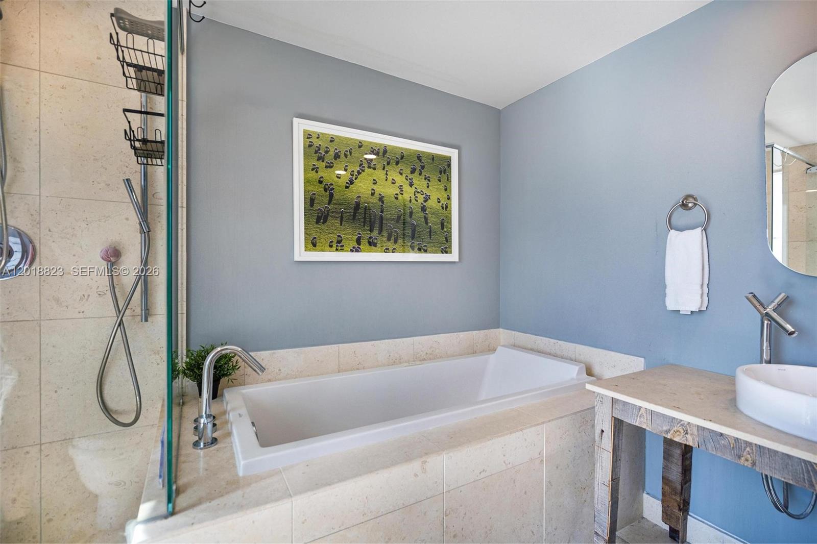 495 Brickell Avenue, Unit 4911 Miami, FL 33131 - Photo 27 of 35 a bathroom with a granite countertop bathtub and a shower