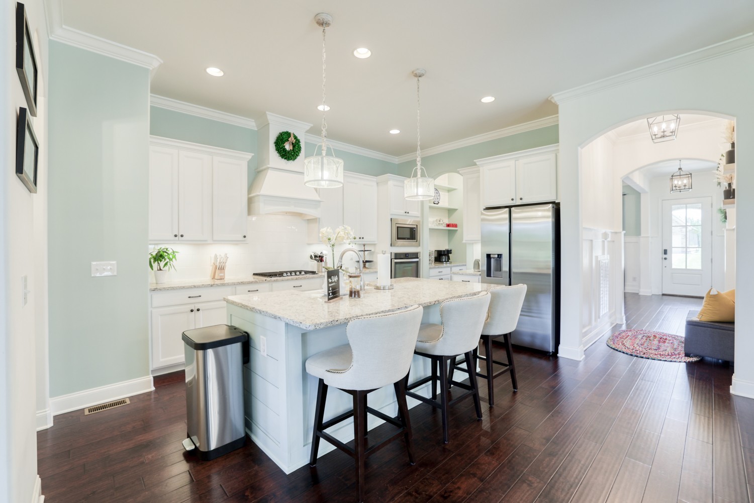 1146 Batbriar Road Murfreesboro, TN 37128 - Photo 15 of 56 a kitchen with stainless steel appliances kitchen island granite countertop a dining table chairs and white cabinets