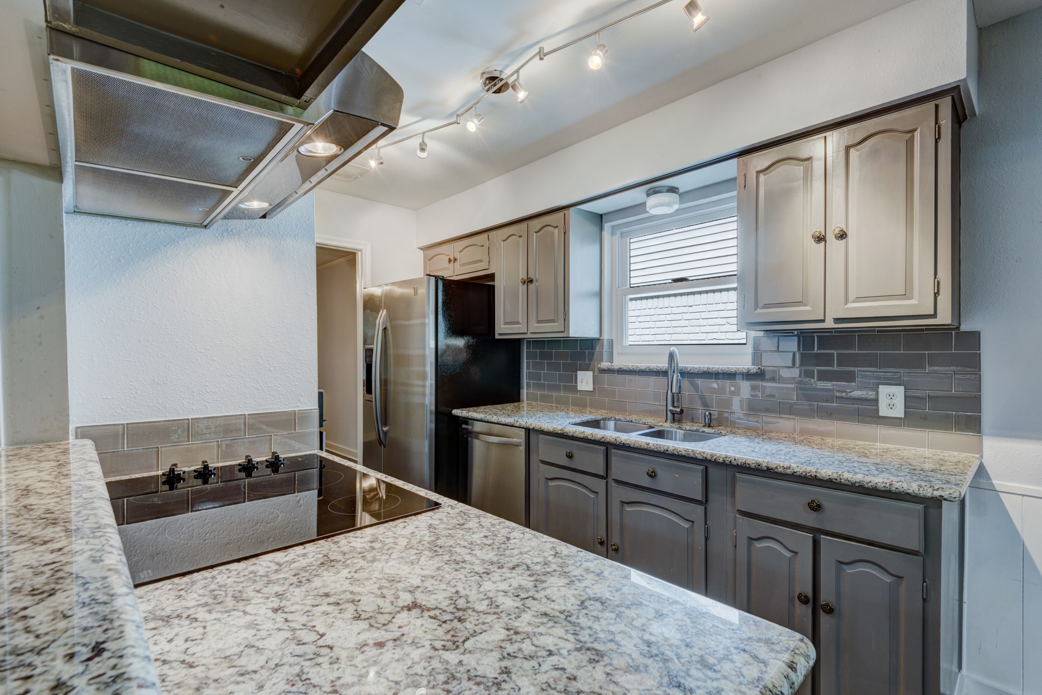 6126 Rena Street Houston, TX 77092 - Photo 14 of 24 a kitchen with stainless steel appliances granite countertop a sink stove and refrigerator