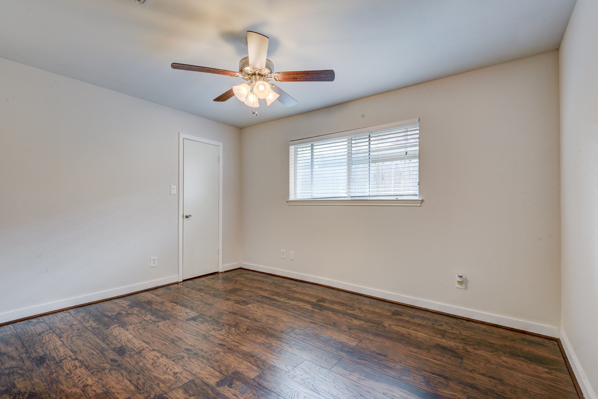 6126 Rena Street Houston, TX 77092 - Photo 17 of 24 wooden floor in an empty room with a window