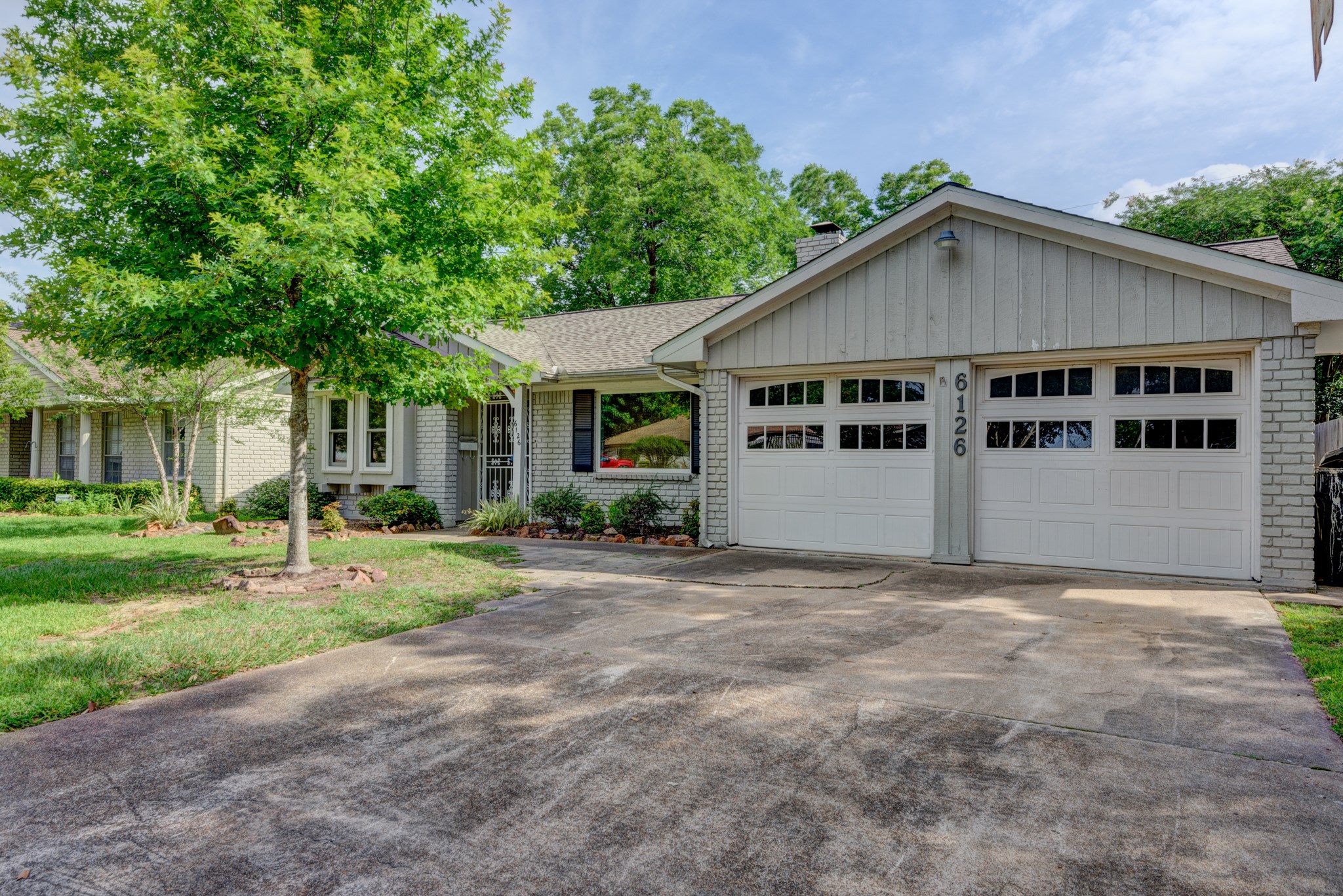 6126 Rena Street Houston, TX 77092 - Photo 2 of 24 a view of a house with a yard and large trees