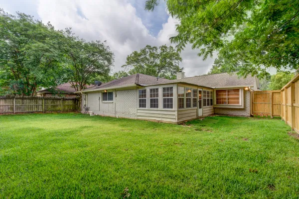 a view of a house with a backyard