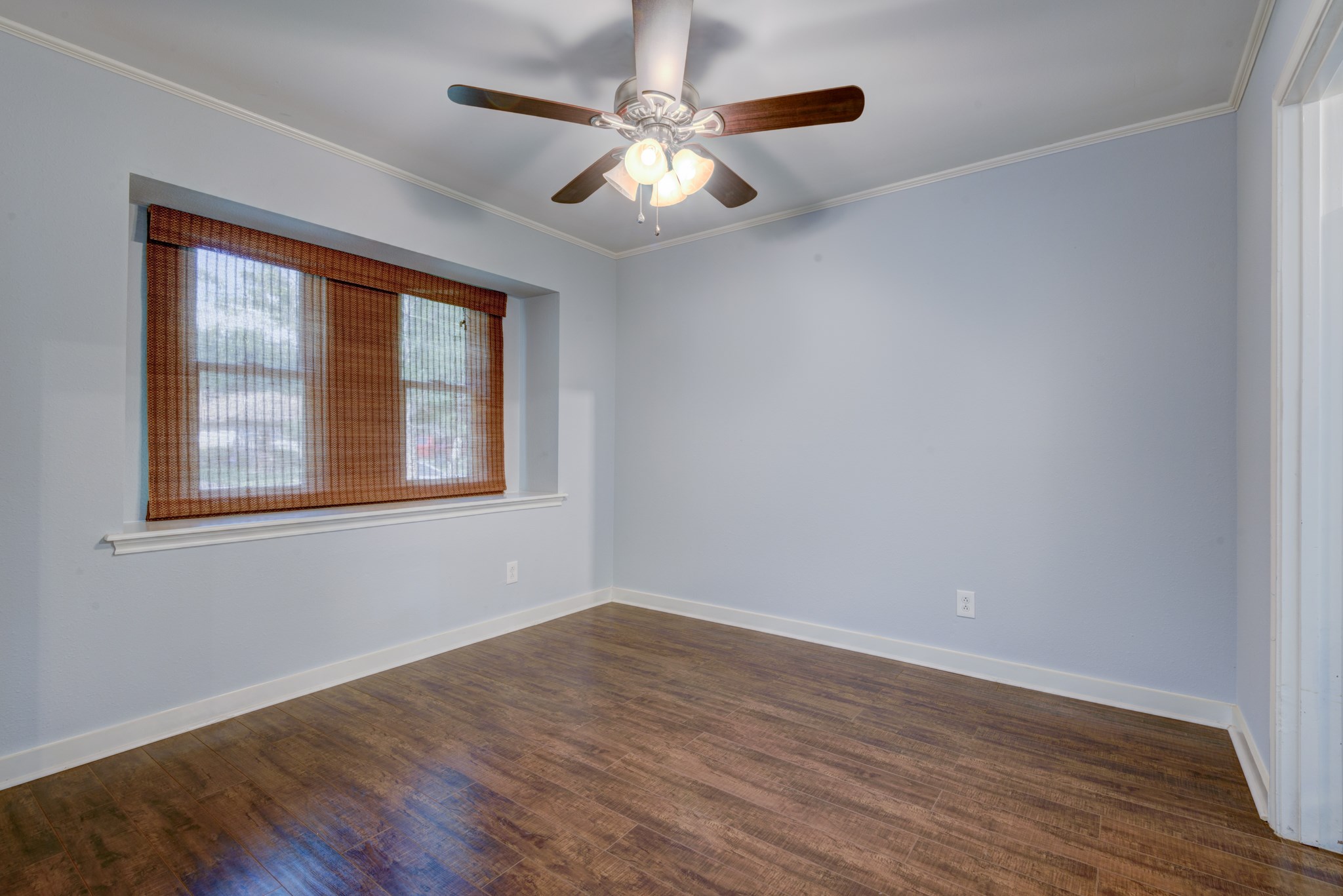 6126 Rena Street Houston, TX 77092 - Photo 6 of 24 a view of an empty room with wooden floor and a window