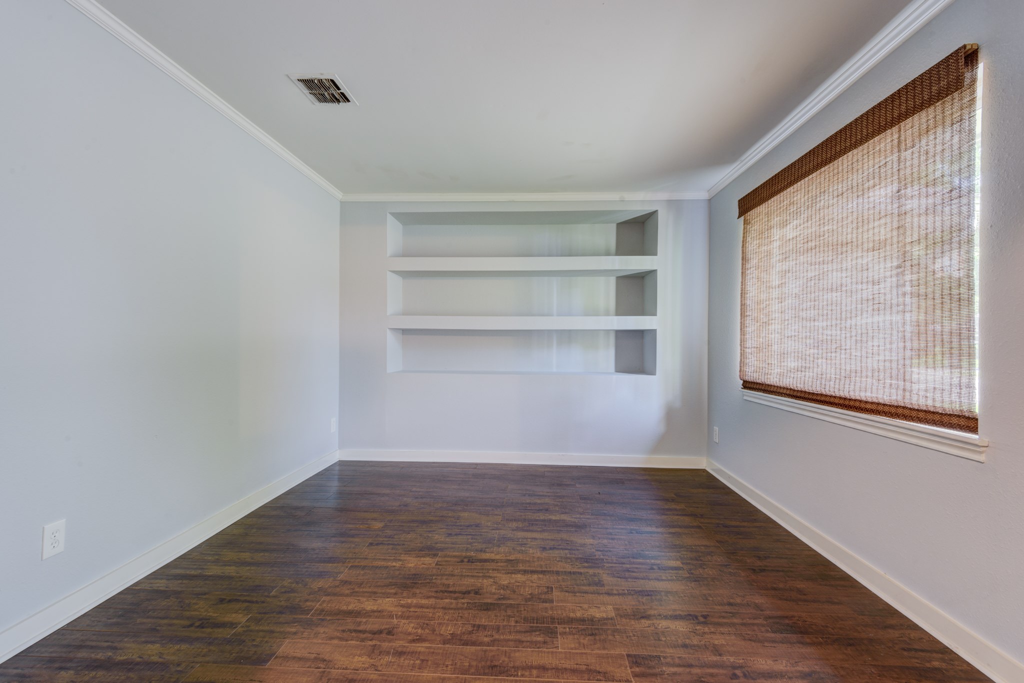 6126 Rena Street Houston, TX 77092 - Photo 7 of 24 a view of an empty room with a window and wooden floor