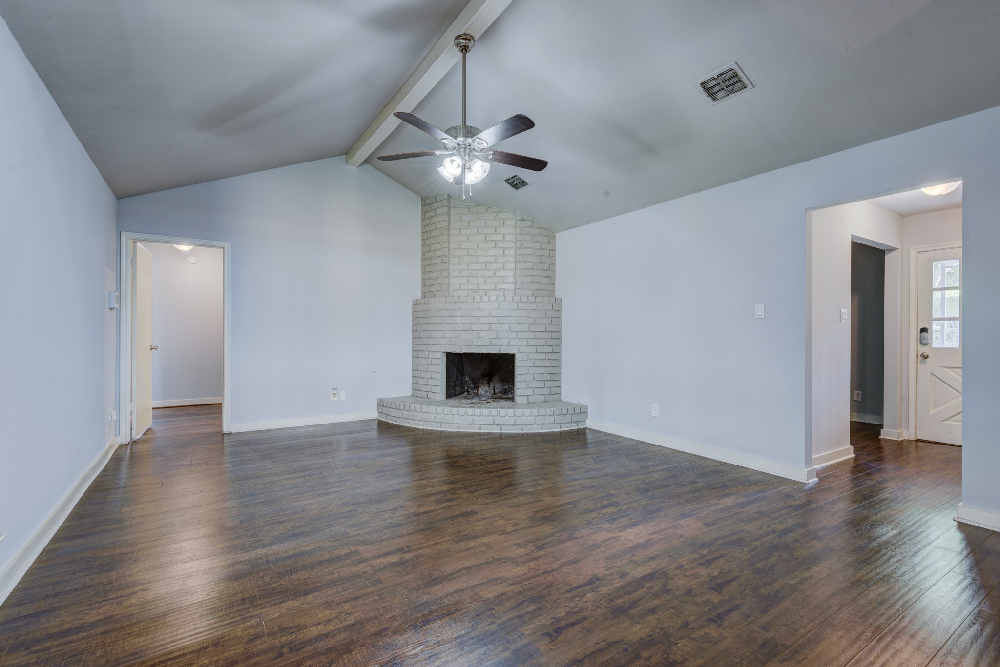 6126 Rena Street Houston, TX 77092 - Photo 9 of 24 a view of an empty room with wooden floor and a fireplace