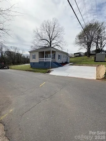 a yellow house with trees in front of it