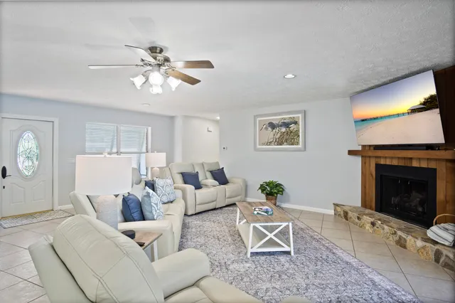 a kitchen with stainless steel appliances a stove a sink a dining table and chairs