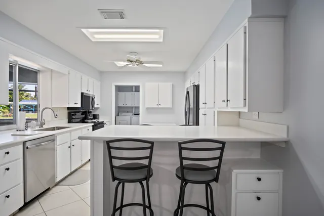 a bathroom with a granite countertop toilet sink and mirror