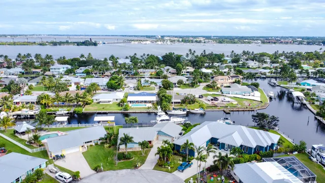 an aerial view of a house with a garden and large trees