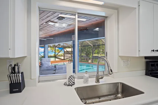 a view of bathroom with a sink and a mirror