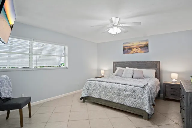 a bedroom with a bed and a painting on the wall