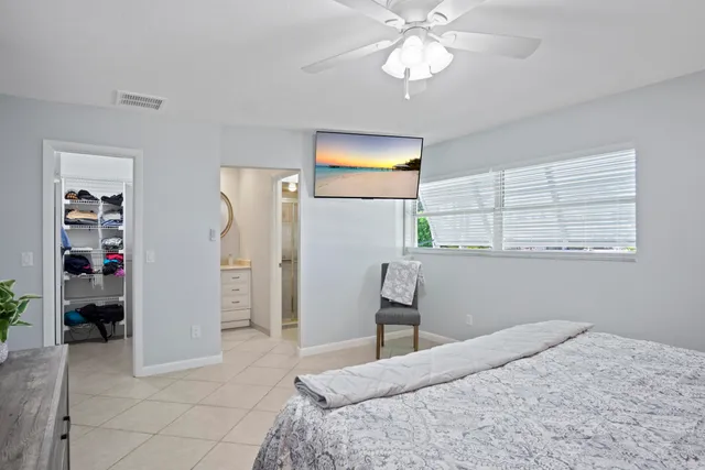 a bedroom with a large bed and a chandelier