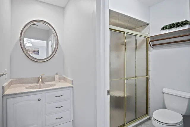 a bathroom with a sink vanity and mirror