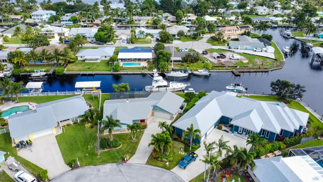 an aerial view of a swimming pool with outdoor seating