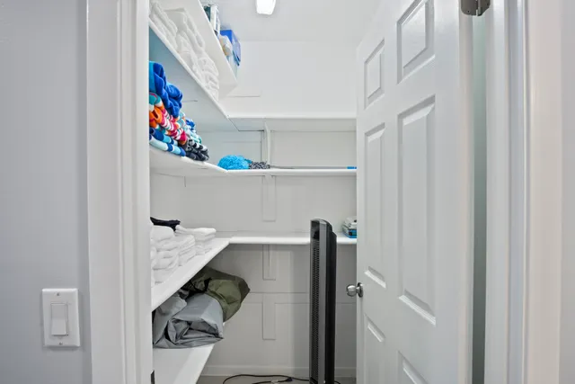 an aerial view of a house with swimming pool and outdoor seating