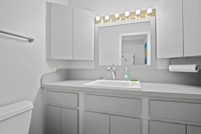 a view of a house with pool and chairs