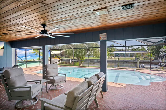 a view of a terrace with lawn chairs