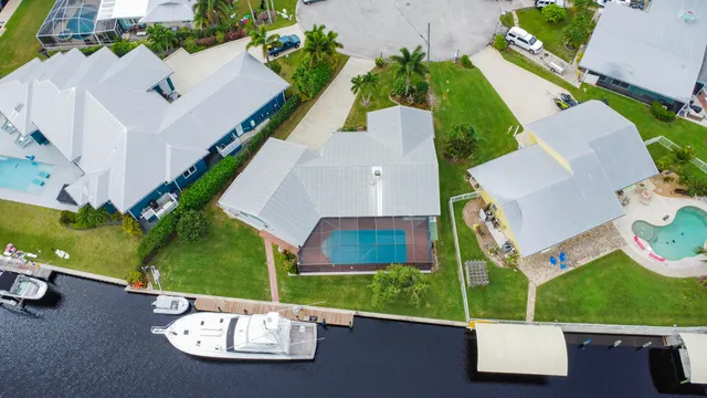 an aerial view of a house with garden space and street view